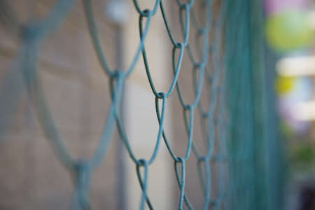 Blue metal fence net as background. Detail of a fence with abstract background.close up steel fence...