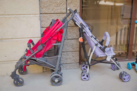 Smooth 2 pram stroller carriage for young baby the image isolated on stone background . Kid...