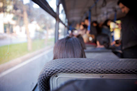People sitting on a comfortable bus in Selective focus and blurred background. s the main mass transit passengers in the bus. People in old public bus, view from inside the bus .の写真素材