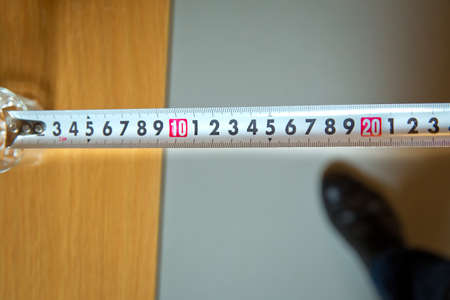 Vintage folding grunge steel meter ruler . Measuring tool. Tape measure. White roulette . Carpenter measuring tape with a metric units scale . Art design roulette templateの写真素材