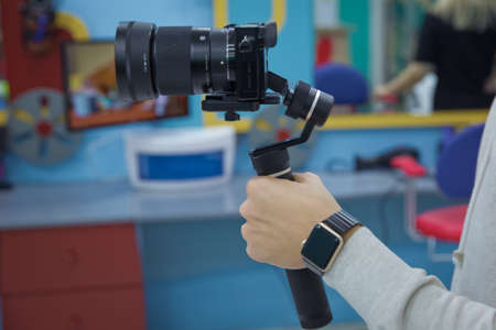 Blogger recording vlog video on camera with at the birthday. Focus on tripod mounted camera screen showing . Digital equipment recording video . Close up successful man recording video, using digitalの写真素材