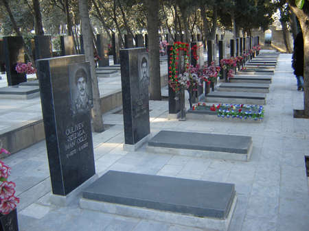 BAKU, AZERBAIJAN - JANUARY 20 2007 Flowers laid in respect by mourners on marble graves at the 20th January Monument in Baku, on the anniversary of massacre of citizens in the capital of Azerbaijanのeditorial素材