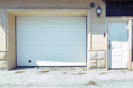 Automatic Electric Roll-up Gate Or Push-up Door In The Modern Building Ground Floor . Shutter door or roller door and concrete floor outside .White Automatic shutters in a house . gates in the garageの写真素材