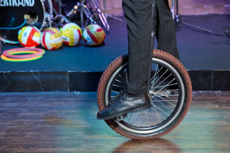mono cyclic, riding mono cycle on a wire above audience. Entertainment for kids. Happy birthday...