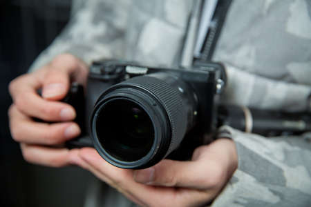 An unidentified man holding gimbal a camera stabilizer . Man holding gimbal stabilizer outdoor. Gimbal Operator with black equipament - Stabilizer and camera filmmakingのeditorial素材