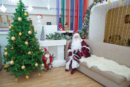 Baku, Azerbaijan . 26.01.2020 . New Year celebration in Azerbaijan kindergarten with Ded Moroz (Grandfather Frost) . The child takes a photo with Santa Claus.のeditorial素材
