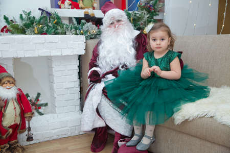 Baku, Azerbaijan . 26.01.2020 . New Year celebration in Azerbaijan kindergarten with Ded Moroz (Grandfather Frost) . The child takes a photo with Santa Claus.のeditorial素材