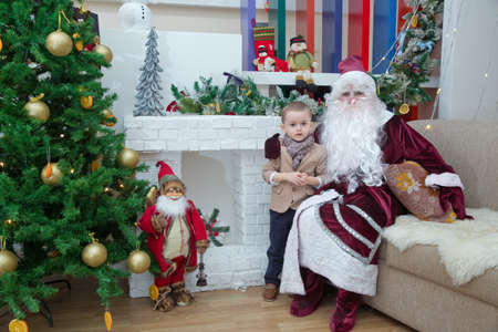 Baku, Azerbaijan . 26.01.2020 . New Year celebration in Azerbaijan kindergarten with Ded Moroz (Grandfather Frost) . The child takes a photo with Santa Claus.のeditorial素材