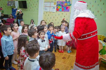 Baku, Azerbaijan . 26.01.2020 . New Year celebration in kindergarten with Ded Moroz Grandfather Frost and Snow-maiden. Little children playing . Santa Claus on New Year's holiday with children.のeditorial素材