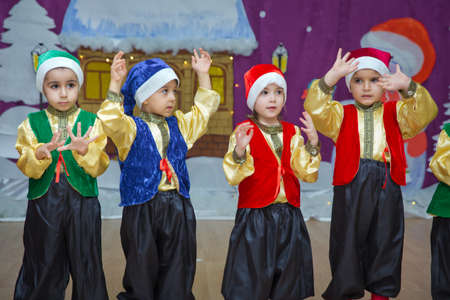 Baku, Azerbaijan . 26.01.2020 . The children are dressed as red Santa Claus. Kindergarten participants take part in a New Year's event. Cute boys dressed in festive costumes of red Santa Clausのeditorial素材