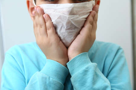 Baku, Azerbaijan. 28.02.2020. Child using the medical face mask . Protection against corona virus . sick kids with medical mask. little kids using face mask to protect their health from pollution smogのeditorial素材