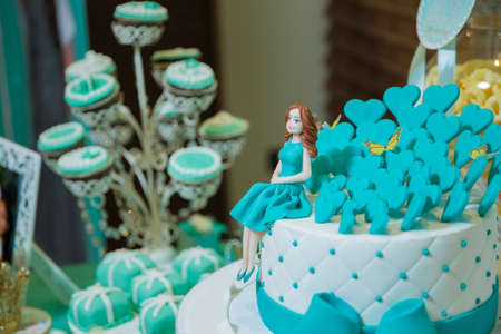 Baku, Azerbaijan. 20.04.2017 . A blue beach themed doll cake . birthday cake for girls . Pastry chef decorates . Top view of homemade gingerbread like girl dolls. Girl doll and aqua cake for birthdayのeditorial素材