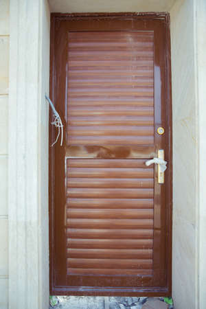 Brown copper metal door. copper door with handle and lockset looks natural tropical and industrial loft . Door for sale in the store.の写真素材