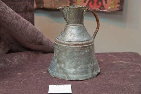 Azerbaijan Baku 04.12.2020 . Various amphorae exhibited in the national arcaeological museum . Copper pottery exhibition . Copper Ewer Jug Ibrik Turkish Ancient Style . An old copper jugのeditorial素材