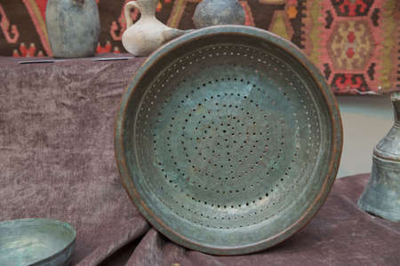 Azerbaijan Baku 04.12.2020 . Various amphorae exhibited in the national arcaeological museum . Copper pottery exhibition . copper strainerのeditorial素材