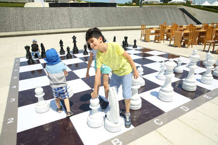 BAKU, AZERBAIJAN - JUNE 1 2019 : Kids festival . In park of Heydar Aliyev Center. Kids play great chess on the groundのeditorial素材