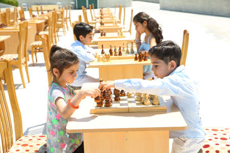 BAKU, AZERBAIJAN - JUNE 1 2019 : Kids festival . In park of Heydar Aliyev Center. Children play chessのeditorial素材