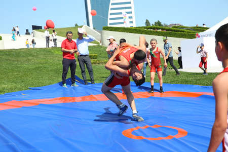 BAKU, AZERBAIJAN - JUNE 1 2019 : Kids festival . In park of Heydar Aliyev Center. Children show the Wrestling Showのeditorial素材