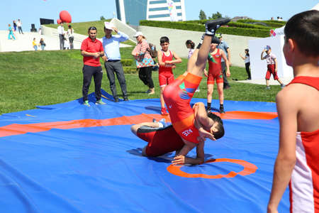 BAKU, AZERBAIJAN - JUNE 1 2019 : Kids festival . In park of Heydar Aliyev Center. Children show the Wrestling Showのeditorial素材