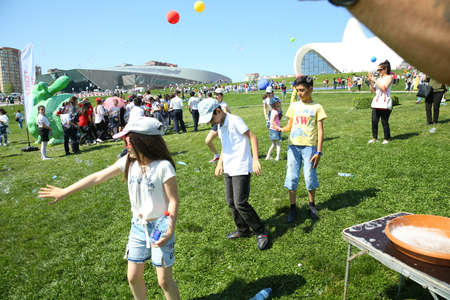 BAKU, AZERBAIJAN - JUNE 1 2019 : Kids festival . In park of Heydar Aliyev Center. Soap bubbles show. Gomel Children's Center.Children at the feast. Soap bubbles show. Children's party.のeditorial素材
