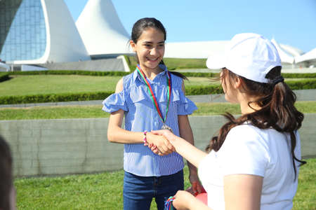 BAKU, AZERBAIJAN - JUNE 1 2019 : Kids festival . In park of Heydar Aliyev Center. Outdoor orienteering check point activity . The children took their place. the children won the Medalsのeditorial素材