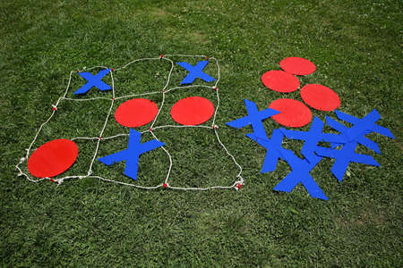 Kids festival . Children play chess . Giant Noughts and Crosses green backgrounds .の写真素材