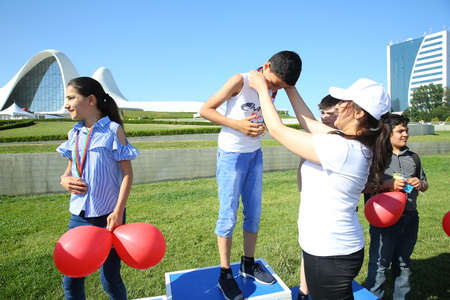 BAKU, AZERBAIJAN - JUNE 1 2019 : Kids festival . In park of Heydar Aliyev Center. Outdoor orienteering check point activity . The children took their place. the children won the Medalsのeditorial素材