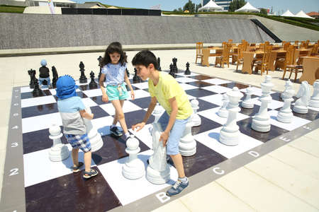 BAKU, AZERBAIJAN - JUNE 1 2019 : Kids festival . In park of Heydar Aliyev Center. Children play chessのeditorial素材