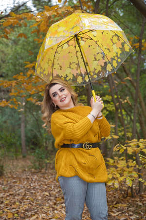 The girl in the yellow dress was holding a yellow umbrella.のeditorial素材