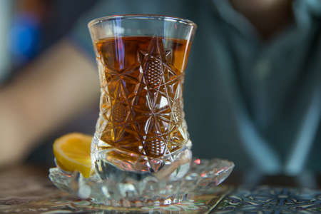 Black turkish tea in pear shape glass, traditional Azerbaijani aromatic tea in armudu cup . Tea in Azerbaijani traditional armudu pear-shaped glass . Azerbaijan black tea .white sugar cubesの写真素材