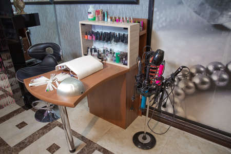 Azerbaijan Baku : 04.02.2018 . Manicure process in beautiful salon . Contemporary manicure tools locating on long desk in beauty salon. Cozy chairs situating near it. Cosmetology salon .のeditorial素材