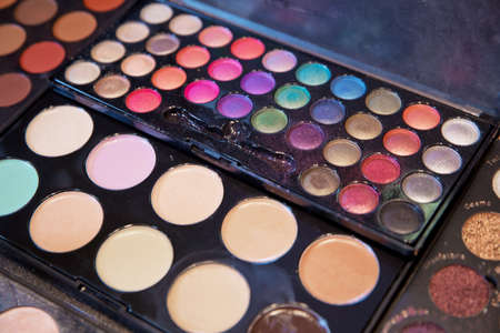 Colorful make-up background. Professional make-up palette . Assortment of different colourful eye shadow palettes in cosmetic store . Palette of shadows for professional make-up .の写真素材
