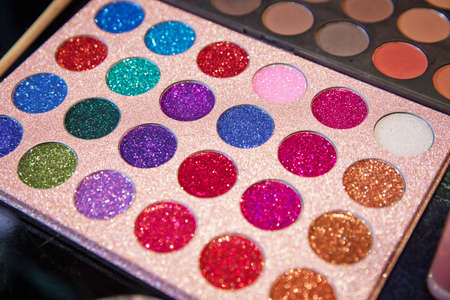 Professional make-up palette . Palette with multi-colored sequins for the eyes. Eye shadow on a black background. Makeup artist tool . glitter palette Vibrant eye shadowの写真素材