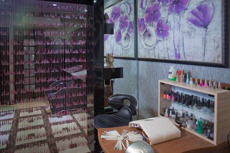 Azerbaijan Baku : 04.02.2018 . Manicure process in beautiful salon . Contemporary manicure tools locating on long desk in beauty salon. Cozy chairs situating near it. Cosmetology salon .の写真素材
