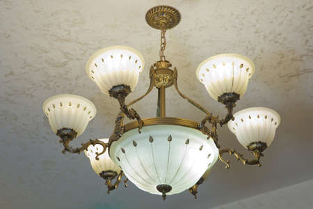 Light fixture Antique chandelier 7 lights solid bronze real alabasters . Close-up of a beautiful crystal chandelier Beautiful chandelier. luxury expensive chandelier hanging under ceilingの写真素材