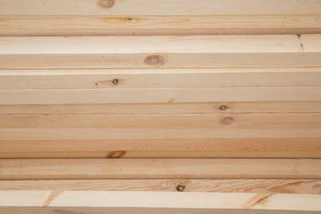Hardware store, construction material for background and texture, Wood products, planks, lining, boards for construction works . Timber industry objects. Finished wood beams or plank at a warehouse.の写真素材