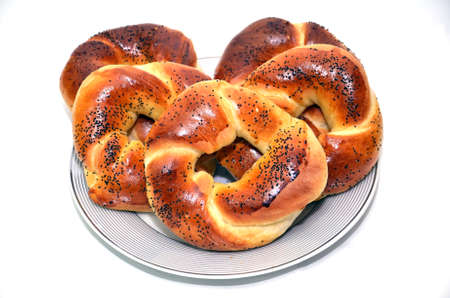 Bublik recipe . Russian national cuisine . Bagel with poppy seeds isolated on white plate background . bagels with poppy seeds isolated on white background .の写真素材
