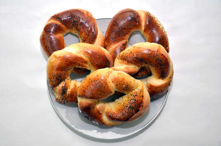 Bublik recipe . Russian national cuisine . Bagel with poppy seeds isolated on white plate background . bagels with poppy seeds isolated on white background .の写真素材