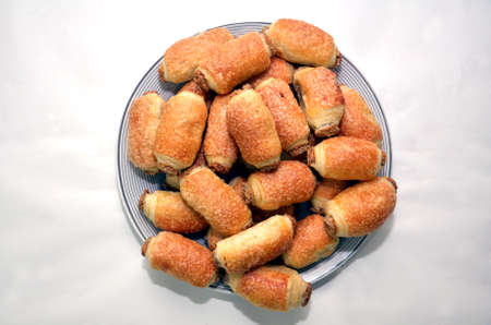 Cinnamon and sugar biscuits called goose feet in a white plate white backgrounds . SWEET BREAKFAST DESSERTS .の写真素材