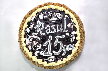 Round black cake with chocolate and nuts. Choco Chip Cake Cake . Round Truffle Cake . 15 years oldの写真素材