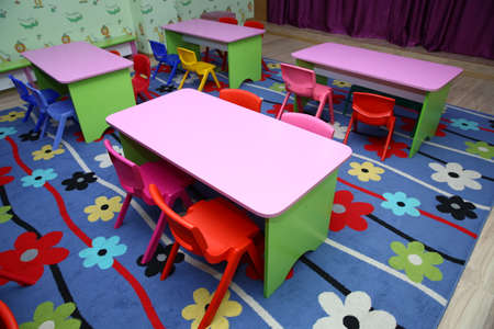 children's furniture and toys in kindergarten . empty tables . refectory of a school for children with chairs and tables without people .の写真素材