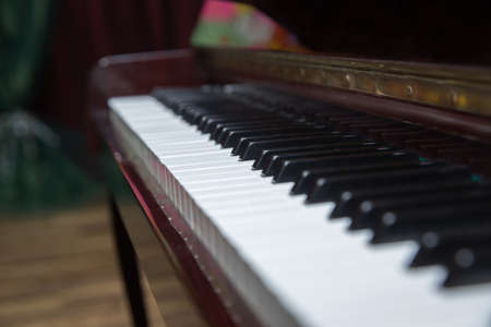 piano presses . Piano keys close up. Musical instrument . Select focus and soft focus.Close-up of a wooden piano . Defocused classic piano keyboard in white and brown colors .の写真素材