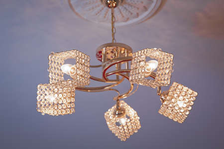 Chandelier Lamp beautiful luxury expensive chandelier hanging under ceiling . The lamp in the beautiful room . Brass chandelier with crystal. beautiful crystal chandelier in a room .の写真素材