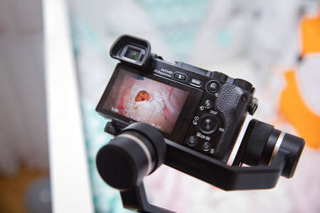 Azerbaijan Baku : 26.06.2020 .Man holding gimbal stabilizer outdoor. Gimbal Operator with black...