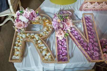 Transparent chocolate box . Yellow and pink letters R and N chocolate .の写真素材
