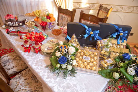Engagement accessories . Engagement basket . Cake, Shekerbura, chocolate Baklava . Azerbaycan Baku . Basket with sweets stands on the table .のeditorial素材