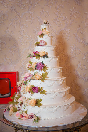 Wedding cake in the hall . Eight Floor Cake . Eight-story white flower cake .の写真素材