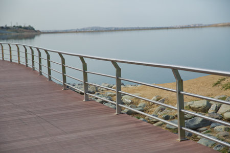 An oval bridge from iron and wood on the edge of the lake . Boyukshor Lake in Baku Azerbaijan . According to geological data, the average depth of the water in the lake is 3.40-3.95 meters .の写真素材