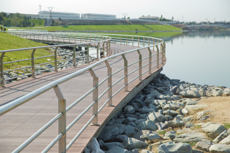 An oval bridge from iron and wood on the edge of the lake . Boyukshor Lake in Baku Azerbaijan . According to geological data, the average depth of the water in the lake is 3.40-3.95 meters .の写真素材