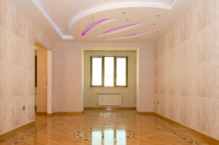 Empty room ready to move in elegant house . Round decorated room . Parquet house . wooden parquet floor and white wall background - empty room, new flat .のeditorial素材